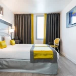 Chambre Twin Supérieure à l’Hôtel Versailles Chantiers avec lits jumeaux, télévision murale et décoration contemporaine